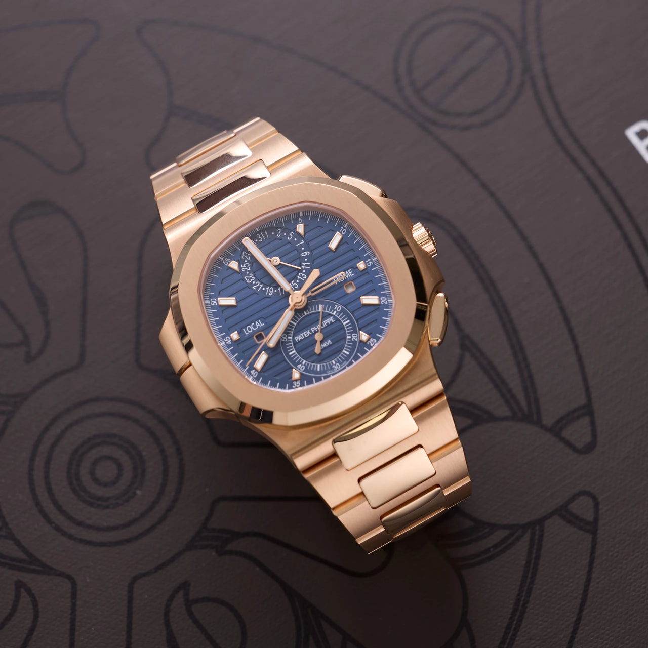 Patek Philippe Nautilus Travel Time Chronograph 18K Rose Gold Blue Dial Ref 5990/1R-001 - angled front view