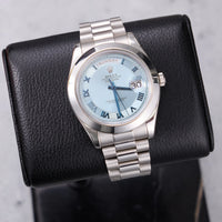 Thumbnail for Rolex Day-Date II 41mm Platinum Ice Blue Concentric Roman Dial Smooth Bezel President Bracelet (Ref 218206) - front view on a black leather display stand