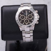 Thumbnail for Rolex Daytona 40mm Stainless Steel Black Dial Tachymeter Bezel Oyster Bracelet (Ref 116520) - front view on a black leather display stand