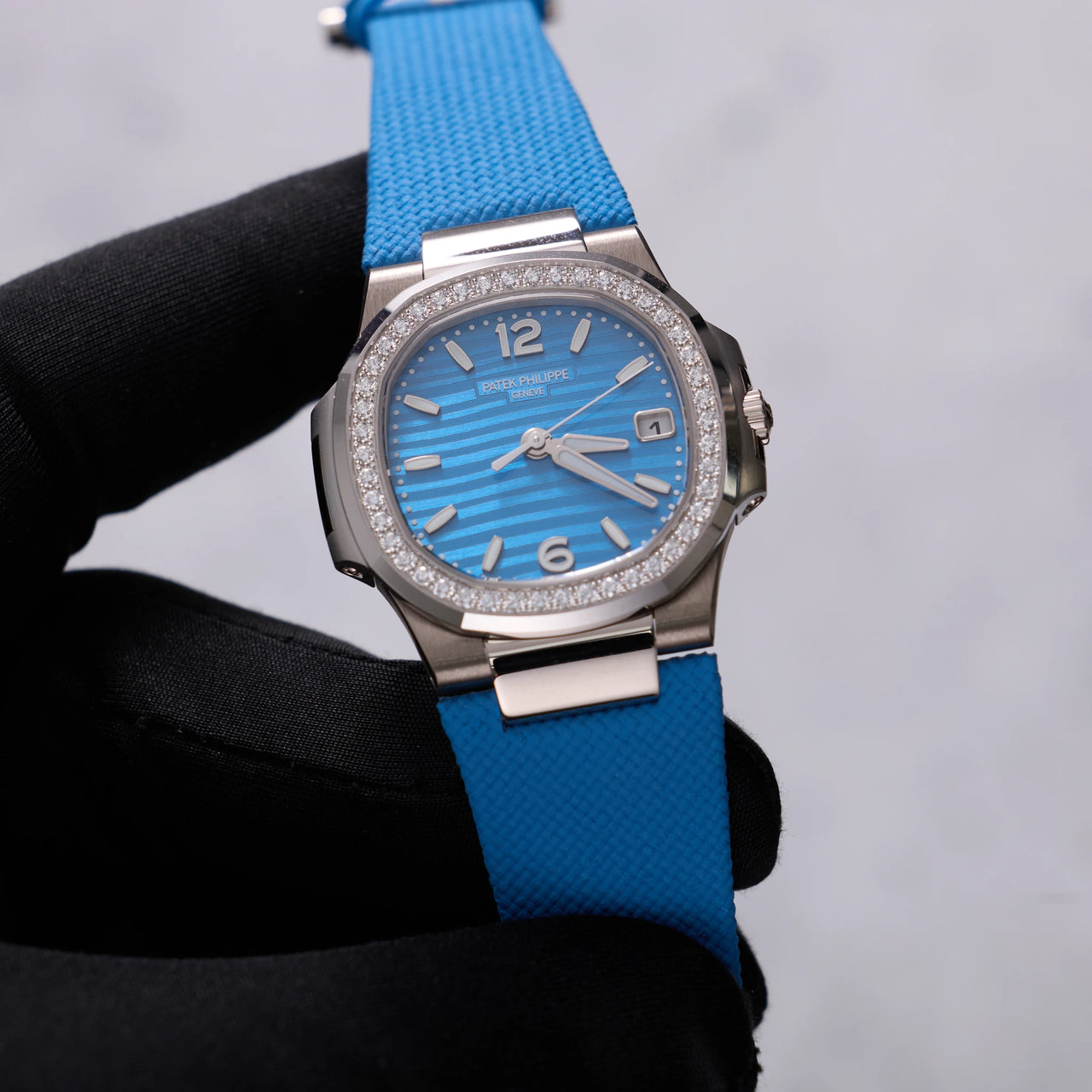 Patek Philippe Nautilus 32mm 18K White Gold Azure Blue Dial Diamond Bezel Ref 7010G-013 - dial view held in hand