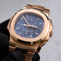 Thumbnail for Patek Philippe Nautilus Travel Time Chronograph 18K Rose Gold Blue Dial Ref 5990/1R-001 - dial view held in hand
