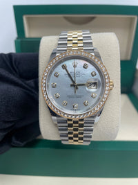 Thumbnail for Rolex Datejust 36mm Steel and Yellow Gold White Mother of Pearl Diamond Dial Diamond Bezel Jubilee Bracelet Ref 126283RBR-0009 - close-up of the white mother-of-pearl diamond dial and diamond bezel, held in hand