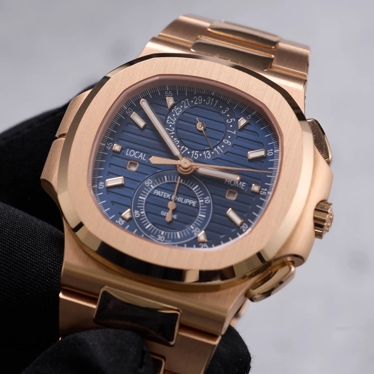 Patek Philippe Nautilus Travel Time Chronograph 18K Rose Gold Blue Dial Ref 5990/1R-001 - dial view held in hand