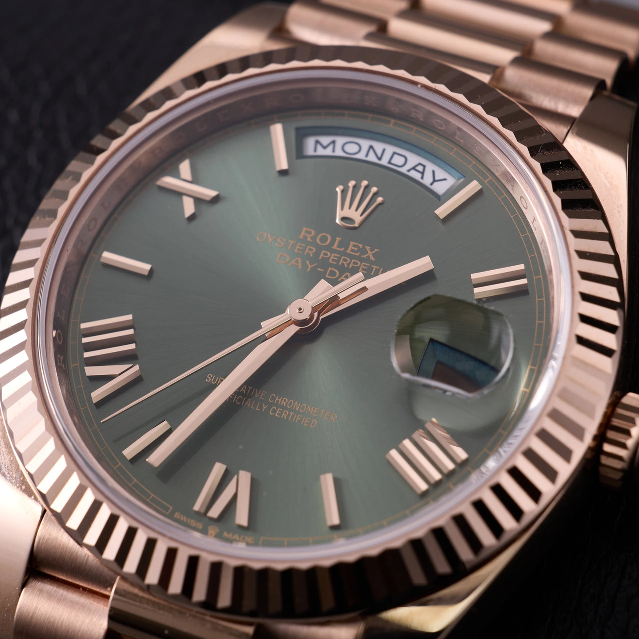 Rolex Day-Date 40mm 18K Everose Gold Olive Green Roman Dial Fluted Bezel President Bracelet (Ref 228235) - close-up of the olive green sunray dial and Everose hands