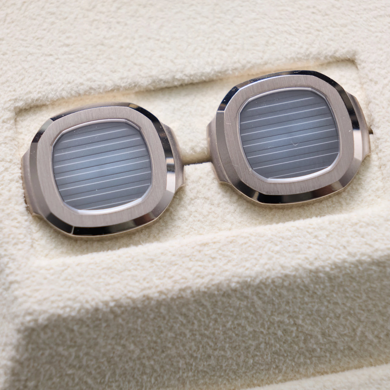 Patek Philippe Nautilus Cufflinks 18K White Gold Blue Dial - pair close-up from a low angle
