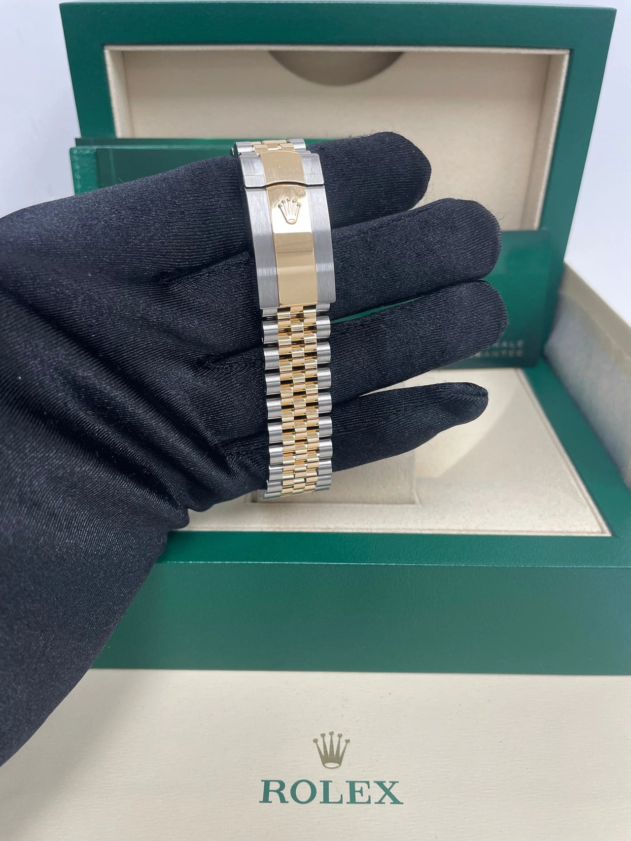 Rolex Datejust 36mm Steel and Yellow Gold White Mother of Pearl Diamond Dial Diamond Bezel Jubilee Bracelet Ref 126283RBR-0009 - Jubilee bracelet and case side, held in hand