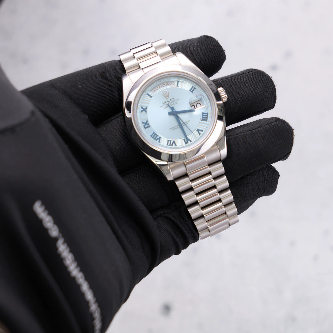 Rolex Day-Date II 41mm Platinum Ice Blue Concentric Roman Dial Smooth Bezel President Bracelet (Ref 218206) - dial view held in hand