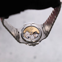 Thumbnail for Patek Philippe Nautilus 40mm Stainless Steel White Dial (Ref 5711/1A-011) - case back held up showing the gold rotor and Patek Philippe Seal