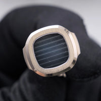 Thumbnail for Patek Philippe Nautilus Cufflinks 18K White Gold Blue Dial - single cufflink face held in a black glove