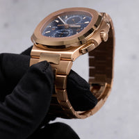 Thumbnail for Patek Philippe Nautilus Travel Time Chronograph 18K Rose Gold Blue Dial Ref 5990/1R-001 - crown side view held in hand
