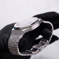 Thumbnail for Audemars Piguet Royal Oak Selfwinding 41mm 18K White Gold Smoked Blue Dial Fixed Bezel Ref 15510BC.OO.1320BC.04 - angled crown side view held in hand