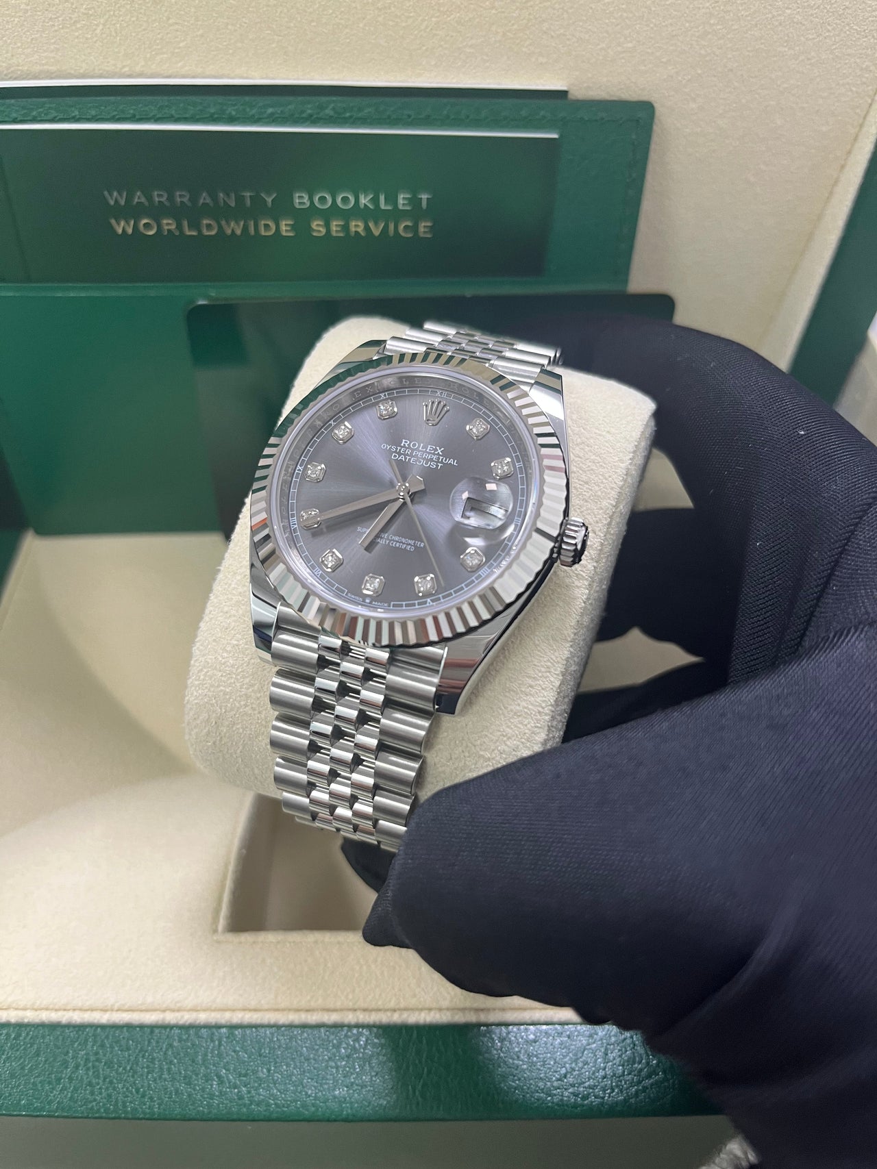 Rolex Datejust 41mm Steel and White Gold Slate Diamond Dial Fluted Bezel Jubilee Bracelet (Ref 126334) - held in hand showing the fluted white gold bezel
