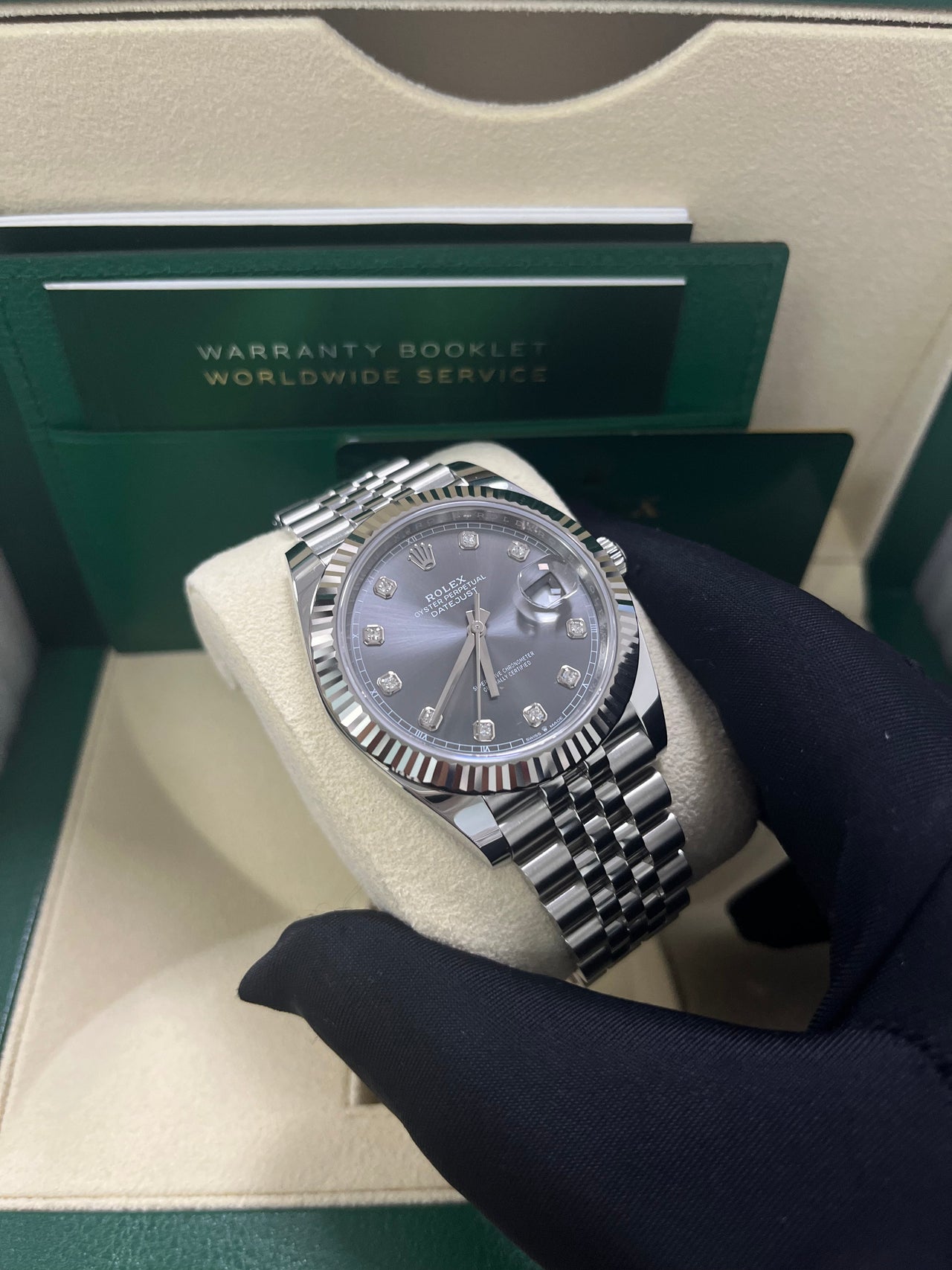 Rolex Datejust 41mm Steel and White Gold Slate Diamond Dial Fluted Bezel Jubilee Bracelet (Ref 126334) - held in hand, angled view of the dial and bracelet