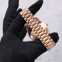 Thumbnail for Rolex Day-Date 40mm 18K Everose Gold Olive Green Roman Dial Fluted Bezel President Bracelet (Ref 228235) - President bracelet and solid caseback, held in hand