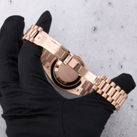 Thumbnail for Rolex Day-Date 40mm 18K Everose Gold Olive Green Roman Dial Fluted Bezel President Bracelet (Ref 228235) - open Crownclasp and solid caseback, held in hand