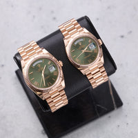Thumbnail for Rolex Day-Date 40mm 18K Everose Gold Olive Green Roman Dial Fluted Bezel President Bracelet (Ref 228235) - on a display stand beside the Day-Date 36 in olive green