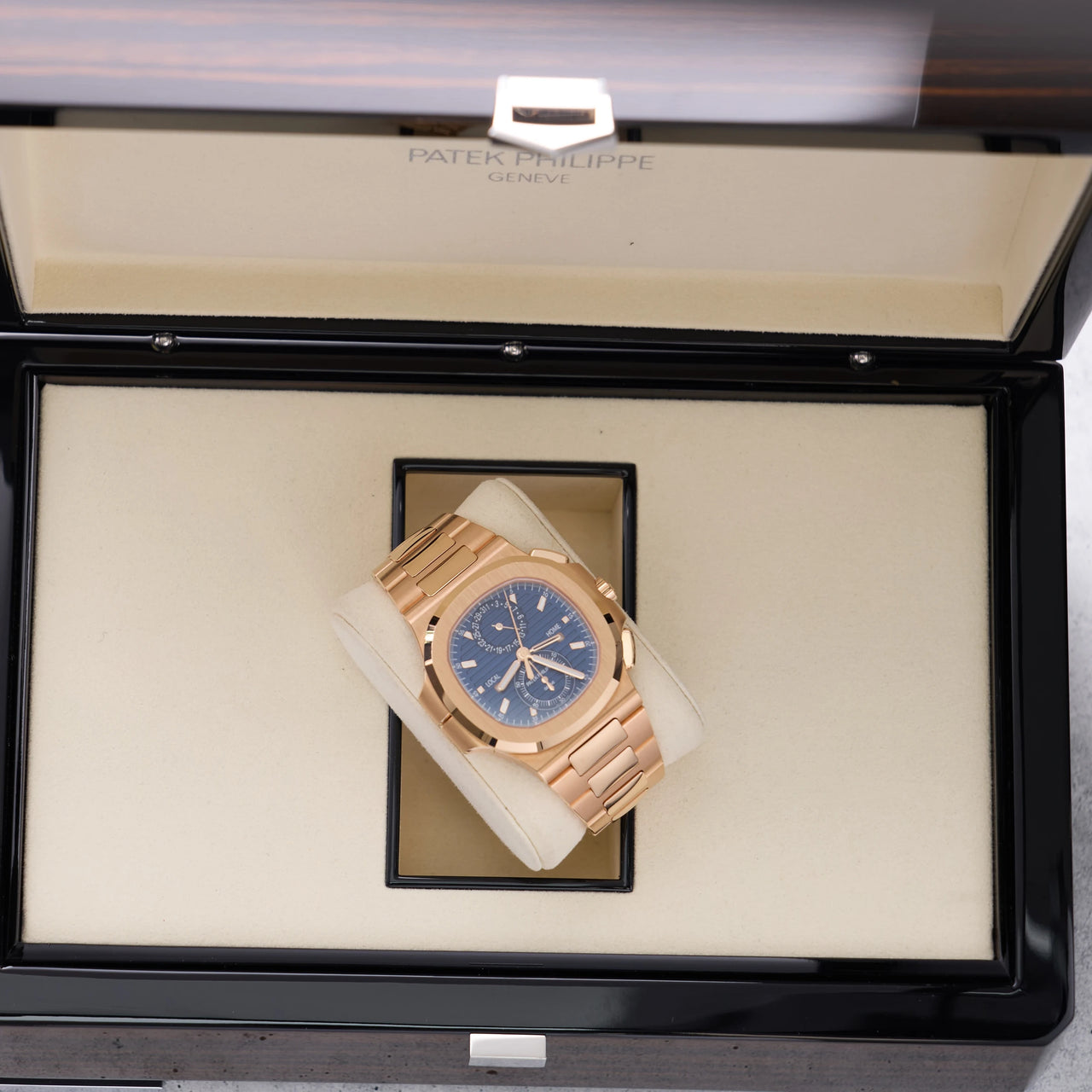 Patek Philippe Nautilus Travel Time Chronograph 18K Rose Gold Blue Dial Ref 5990/1R-001 - angled view in Patek Philippe presentation box